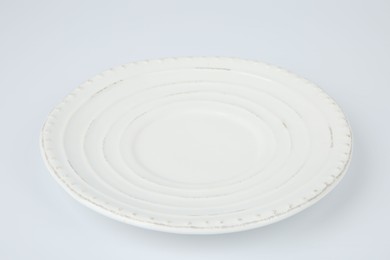 One empty ceramic plate on white background