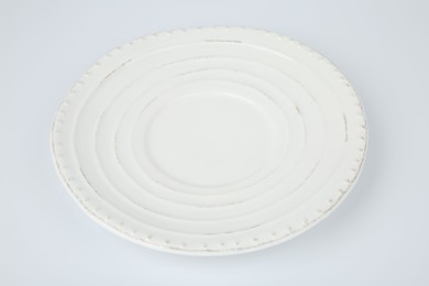 One empty ceramic plate on white background