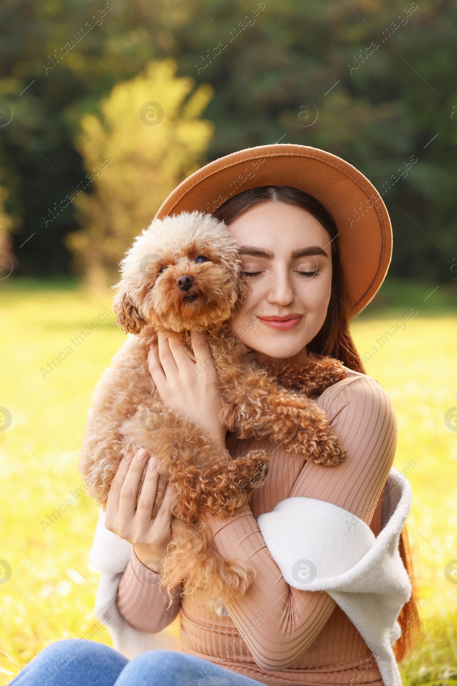 Photo of Woman with cute dog in autumn park