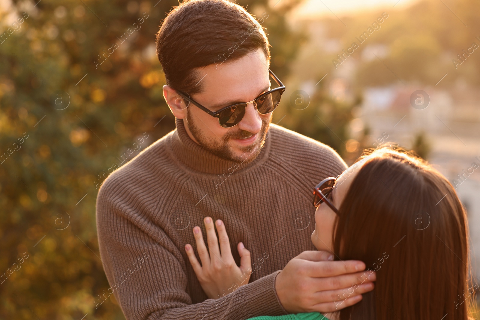 Photo of Cute couple enjoying their time together outdoors in autumn evening