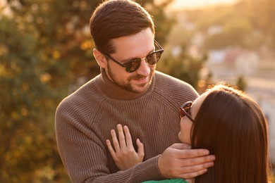 Photo of Cute couple enjoying their time together outdoors in autumn evening