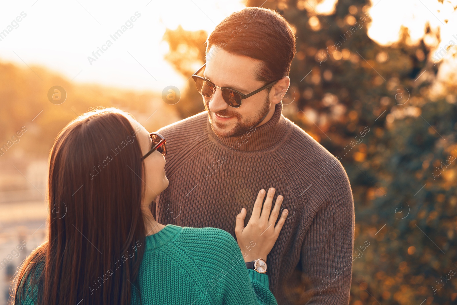 Photo of Cute couple enjoying their time together outdoors in autumn evening