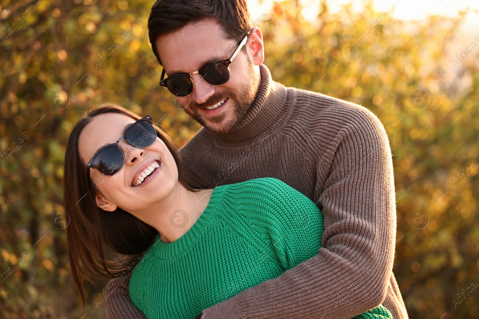 Photo of Beautiful happy couple hugging outdoors in autumn evening