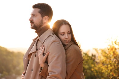 Beautiful couple enjoying their time together outdoors in autumn evening