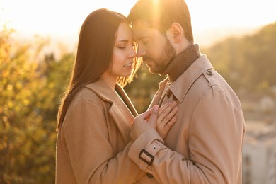 Beautiful couple enjoying their time together outdoors in autumn evening