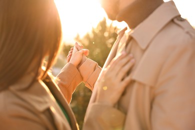 Beautiful couple dancing outdoors on sunset, closeup