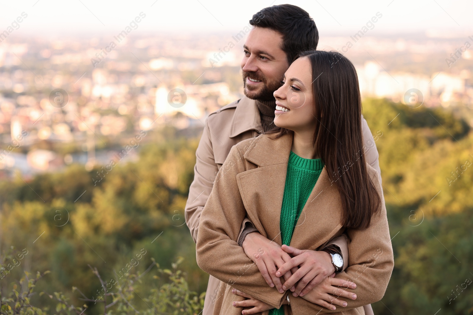 Photo of Beautiful happy couple hugging outdoors on autumn day