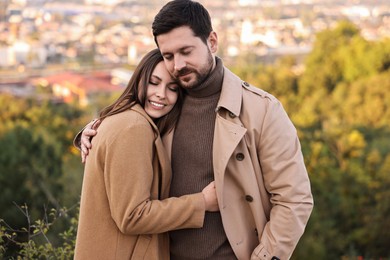 Photo of Beautiful couple hugging in park on autumn day