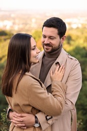 Photo of Beautiful couple hugging in park on autumn day