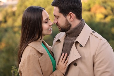 Beautiful couple spending time together outdoors on autumn day