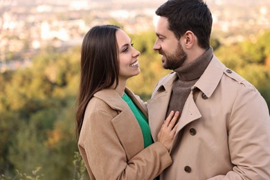 Beautiful couple spending time together outdoors on autumn day