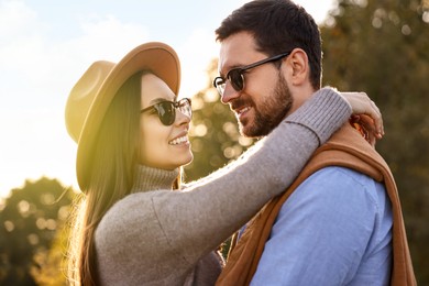 Photo of Beautiful couple spending time together in autumn park