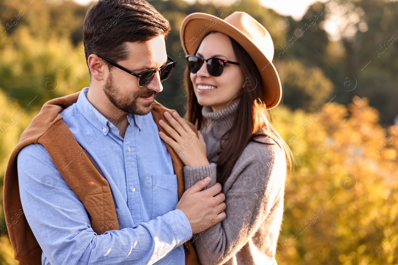 Photo of Beautiful happy couple in sunglasses outdoors on autumn day