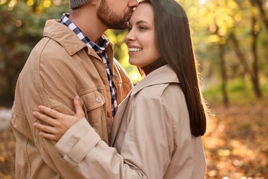 Beautiful couple enjoying their time in park on autumn day, closeup