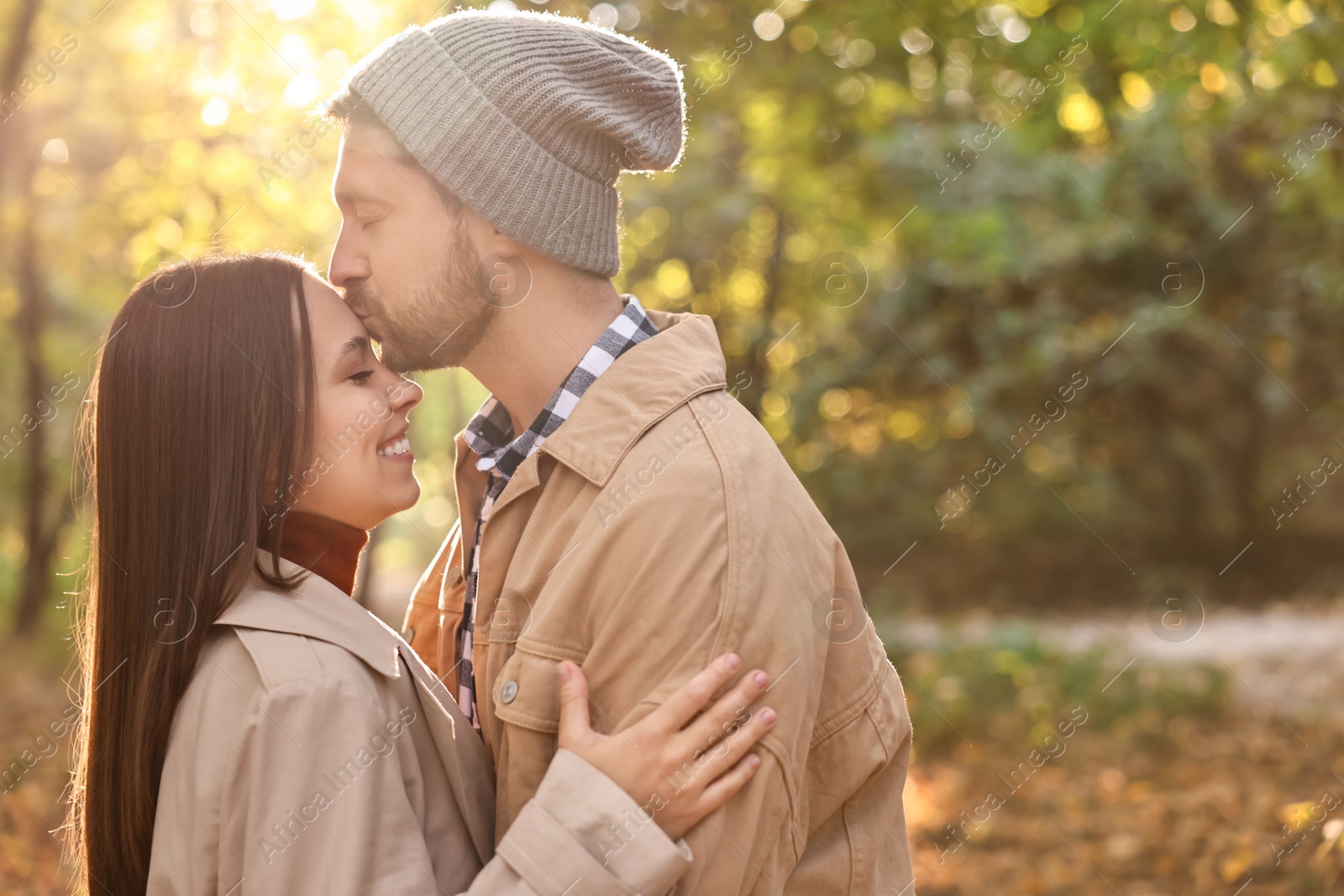 Photo of Beautiful couple spending time in park on autumn day, space for text