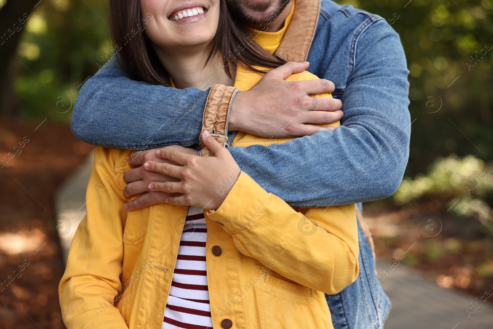 Photo of Couple hugging in autumn park, closeup view