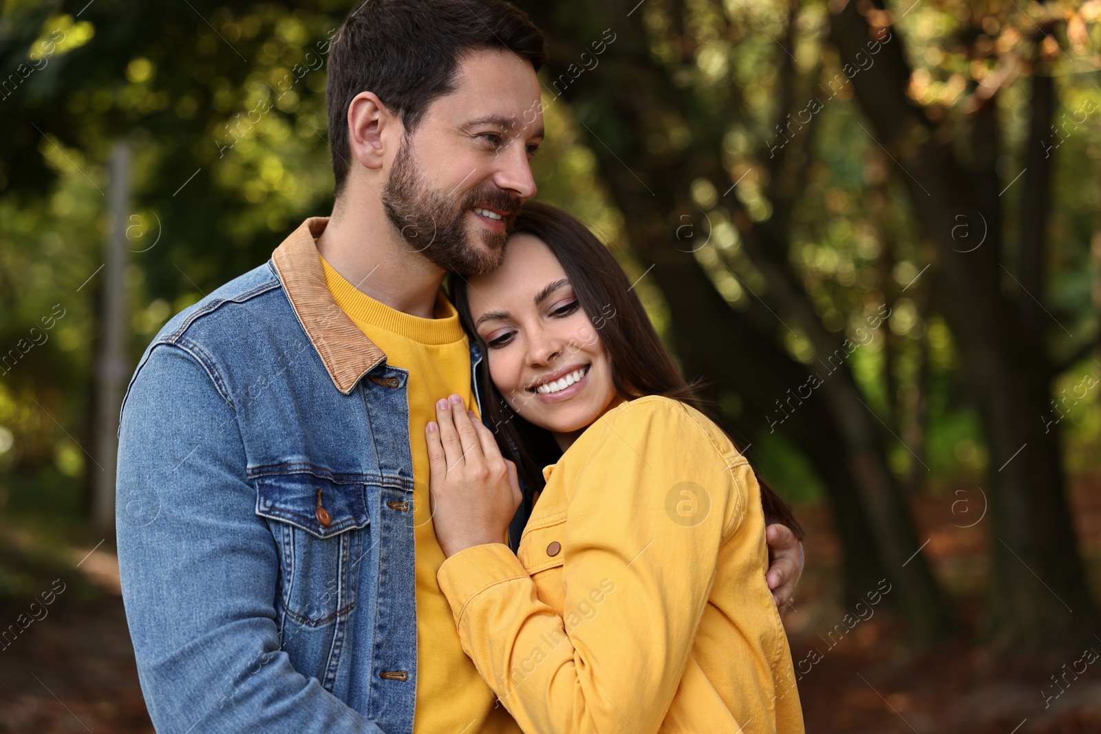 Photo of Beautiful couple hugging in park on autumn day