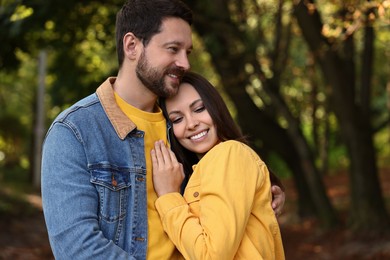 Photo of Beautiful couple hugging in park on autumn day