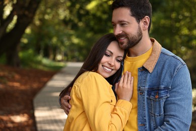 Photo of Beautiful couple hugging in park on autumn day