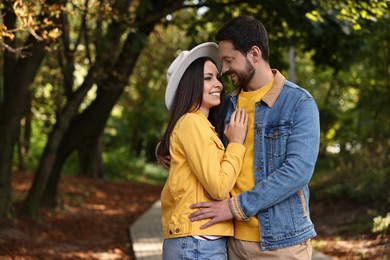 Beautiful couple hugging in park on autumn day