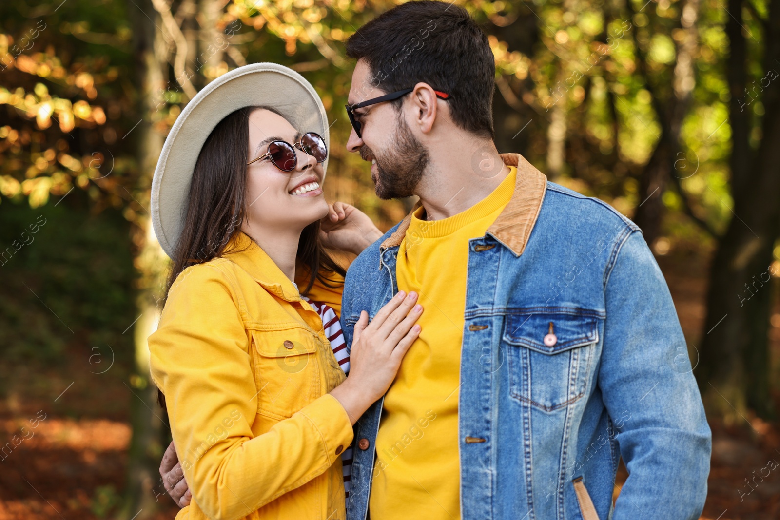 Photo of Beautiful couple hugging in park on autumn day