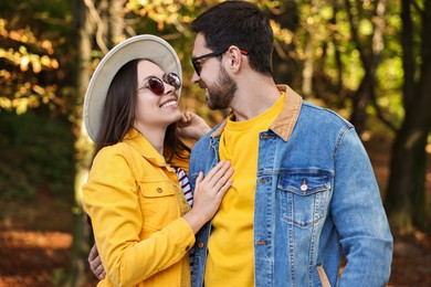 Photo of Beautiful couple hugging in park on autumn day