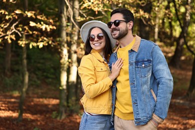 Photo of Beautiful couple hugging in park on autumn day