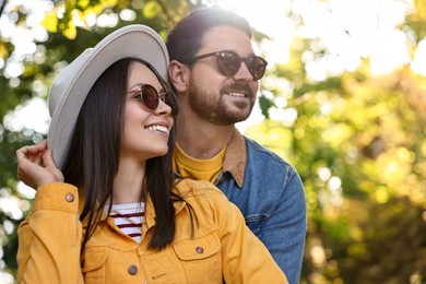 Photo of Beautiful couple in park on autumn day, low angle view