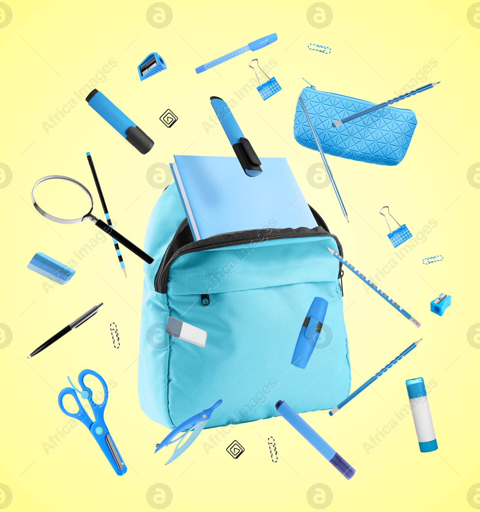 Image of Backpack and school stationery in air on light yellow background