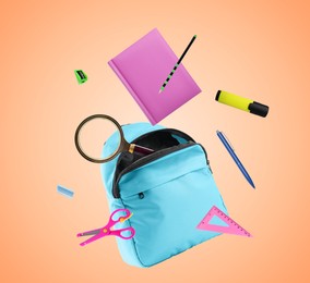 Image of Light blue backpack and school stationery in air on pale coral background