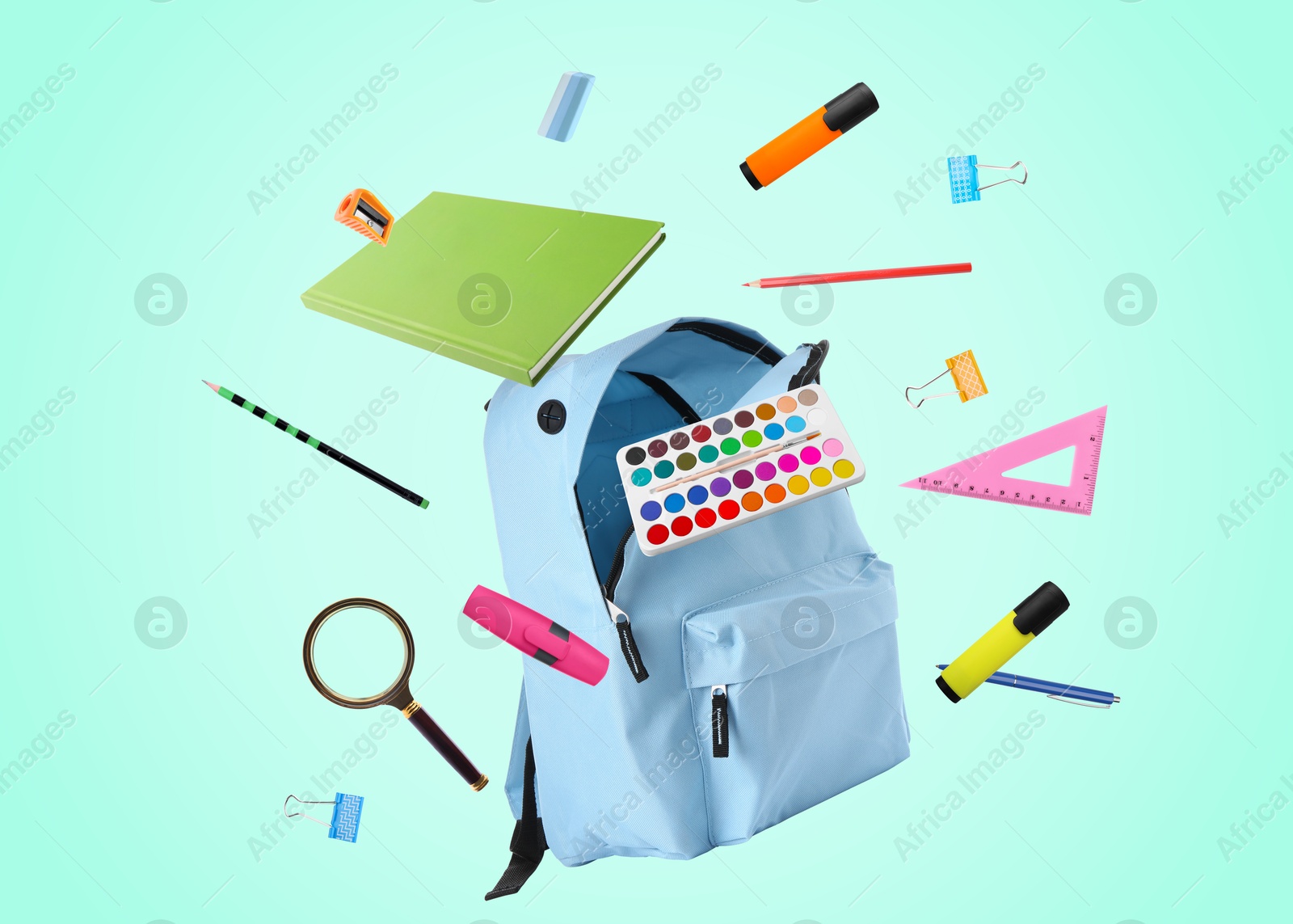 Image of Light blue backpack and school stationery in air on turquoise background