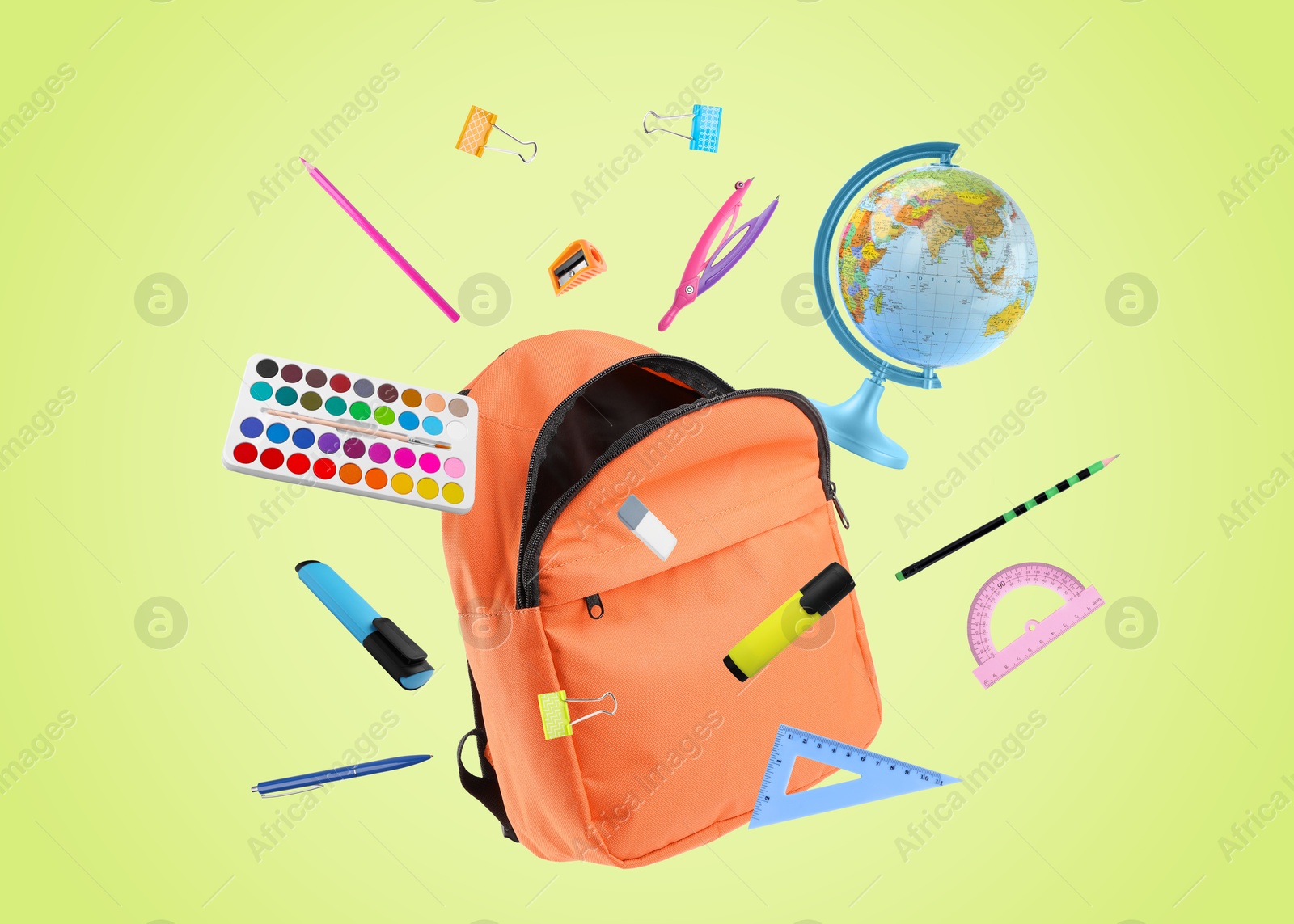 Image of Orange backpack and school stationery in air on light green background