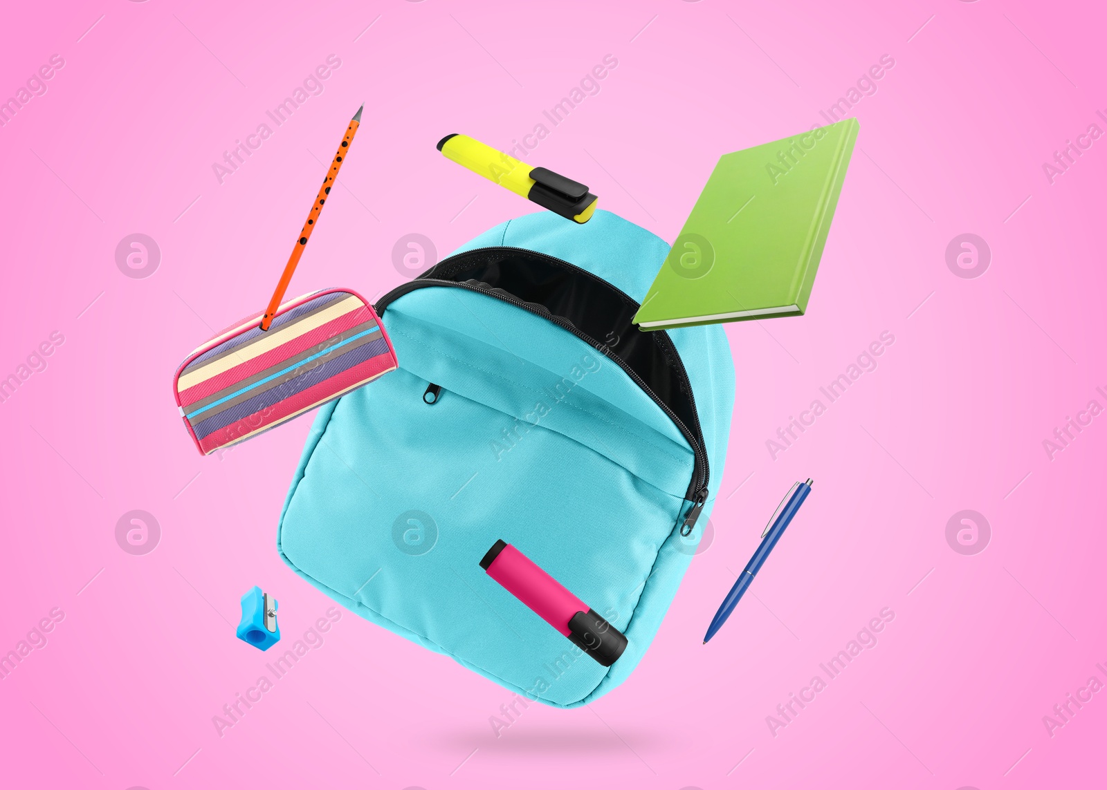 Image of Light blue backpack and school stationery in air on pink background