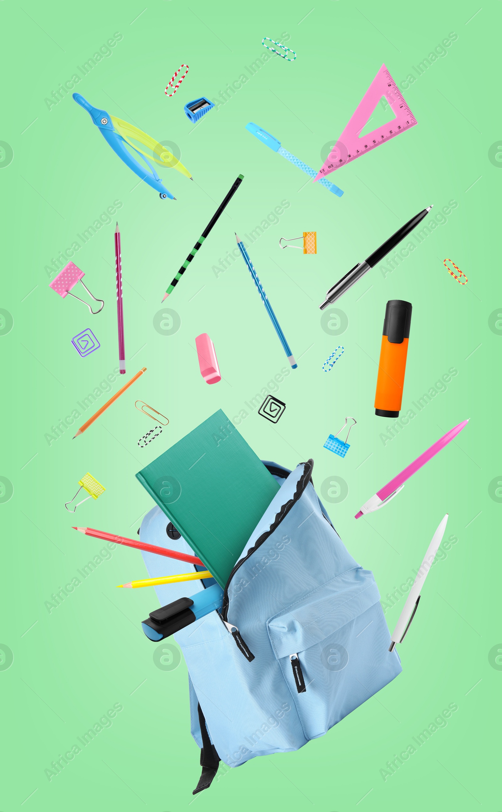 Image of Light blue backpack and school stationery in air on aquamarine color background