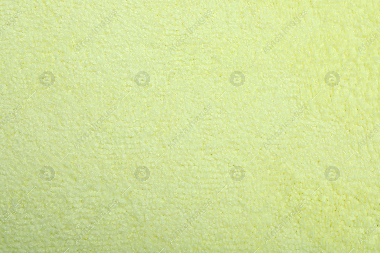 Photo of Pale yellow microfiber cloth as background, top view