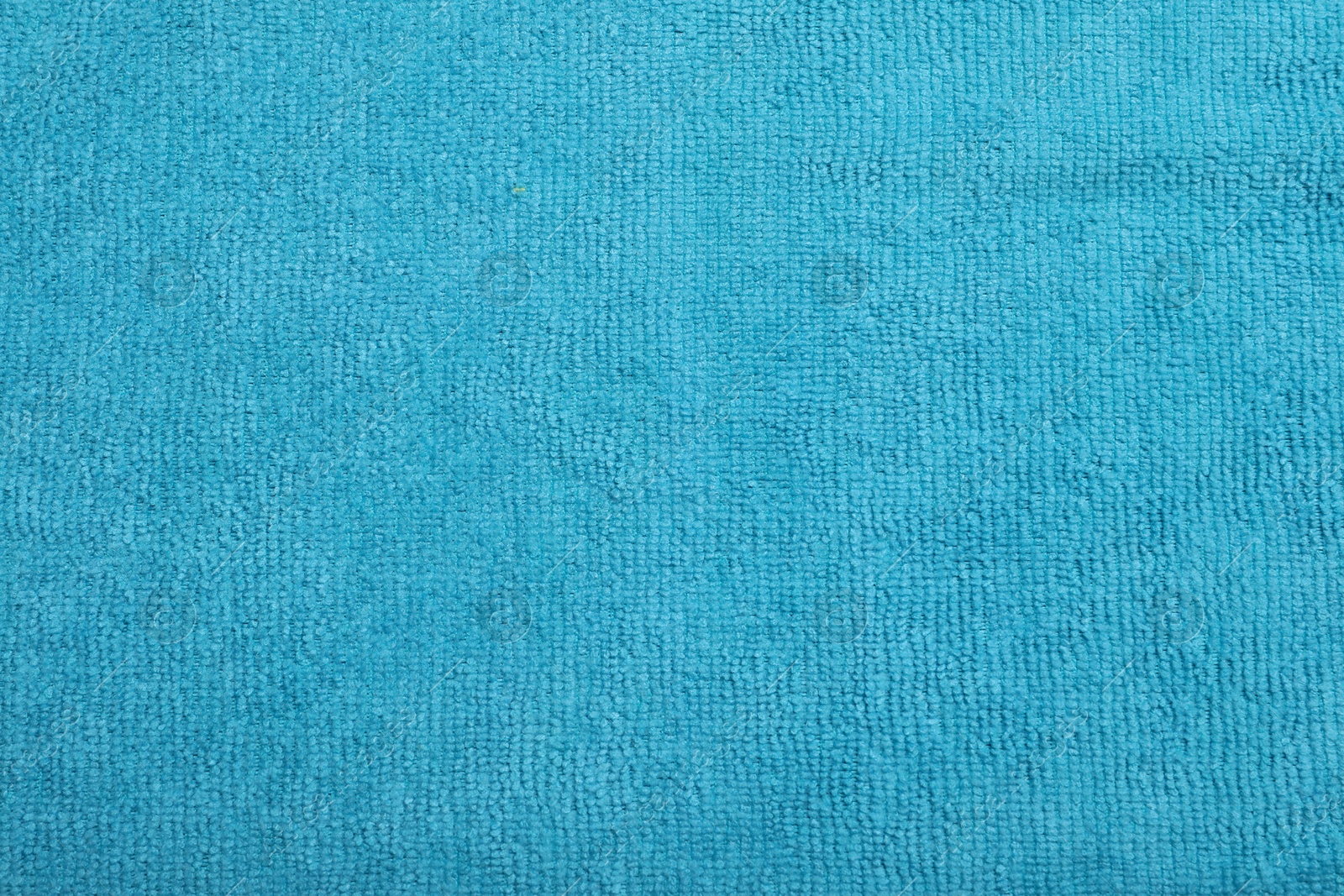 Photo of Light blue microfiber cloth as background, top view