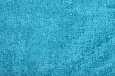 Light blue microfiber cloth as background, top view