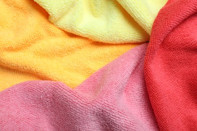 Photo of Many colorful microfiber cloths as background, closeup