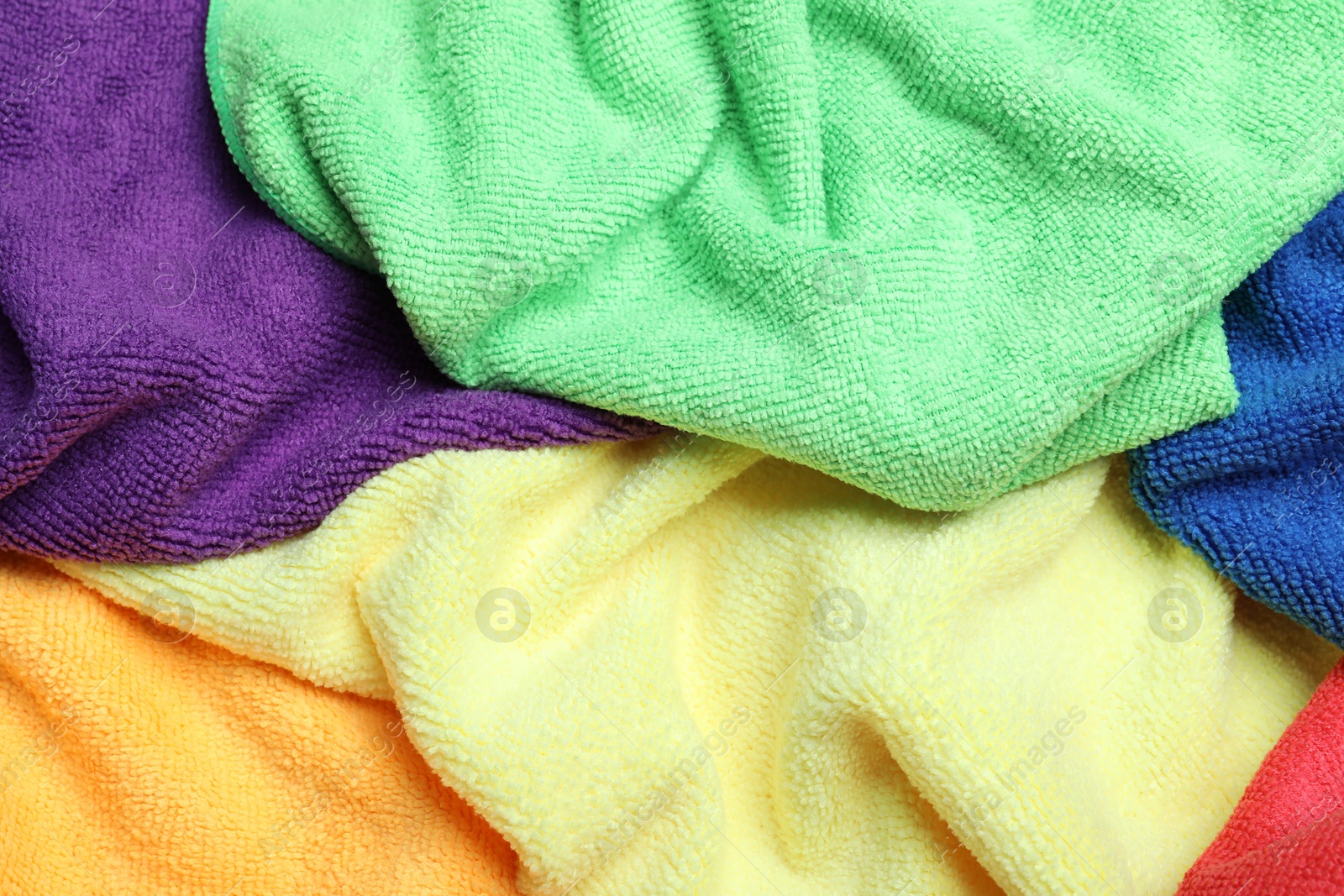 Photo of Many colorful microfiber cloths as background, closeup