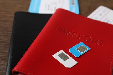 Photo of Passports and SIM cards on table, closeup