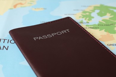 Photo of One passport on world map, closeup view