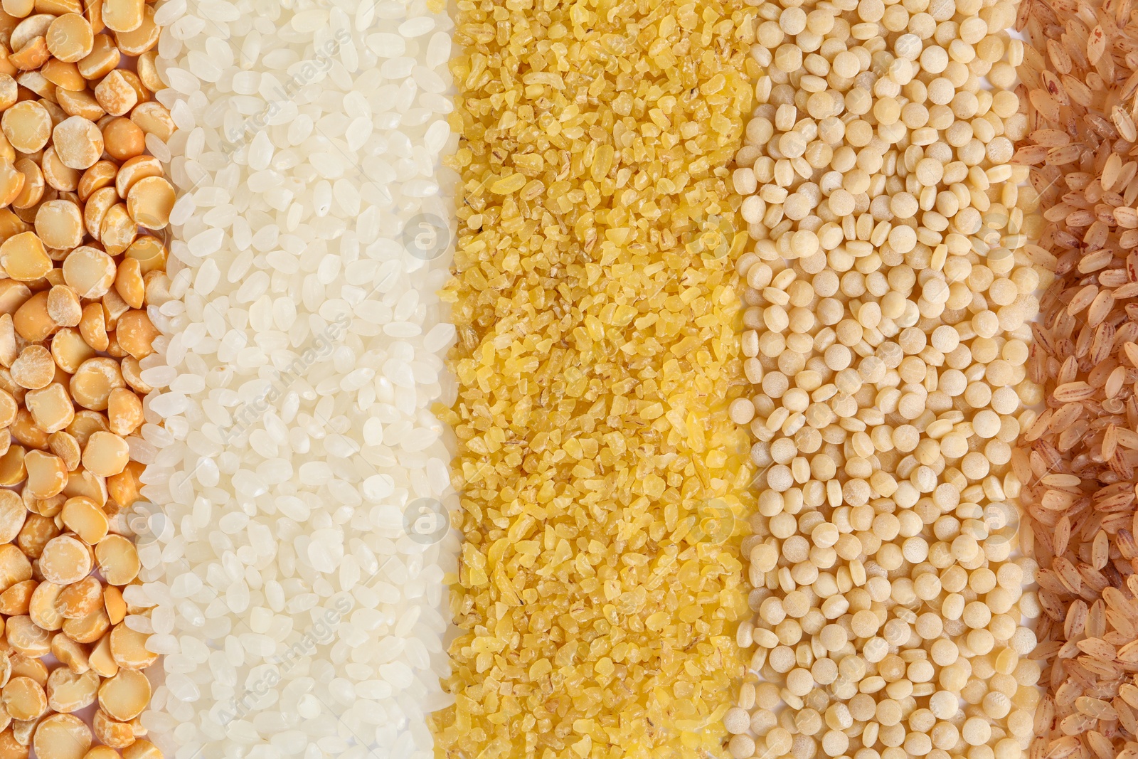 Photo of Different cereal grains as background, top view