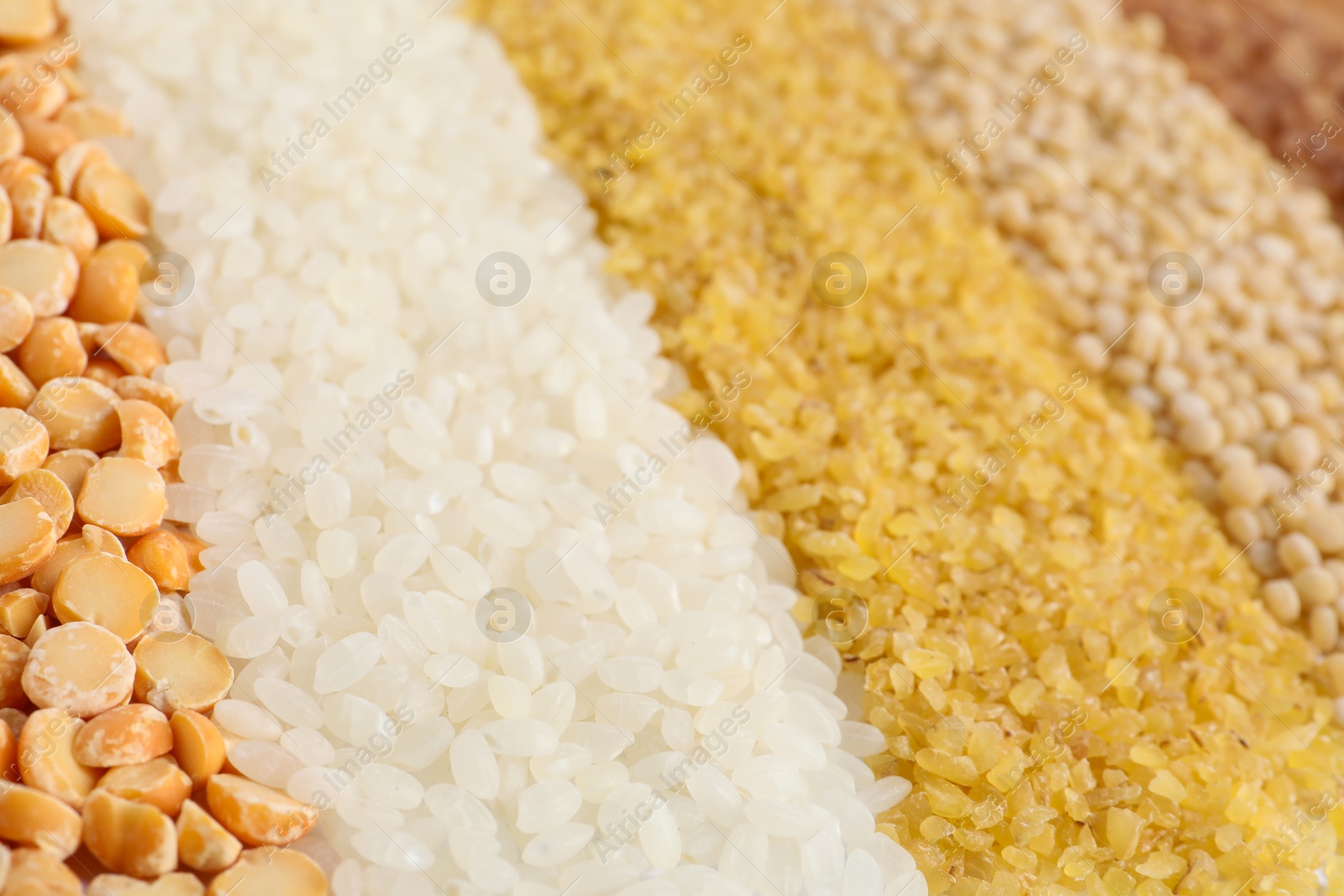 Photo of Different cereal grains as background, closeup view