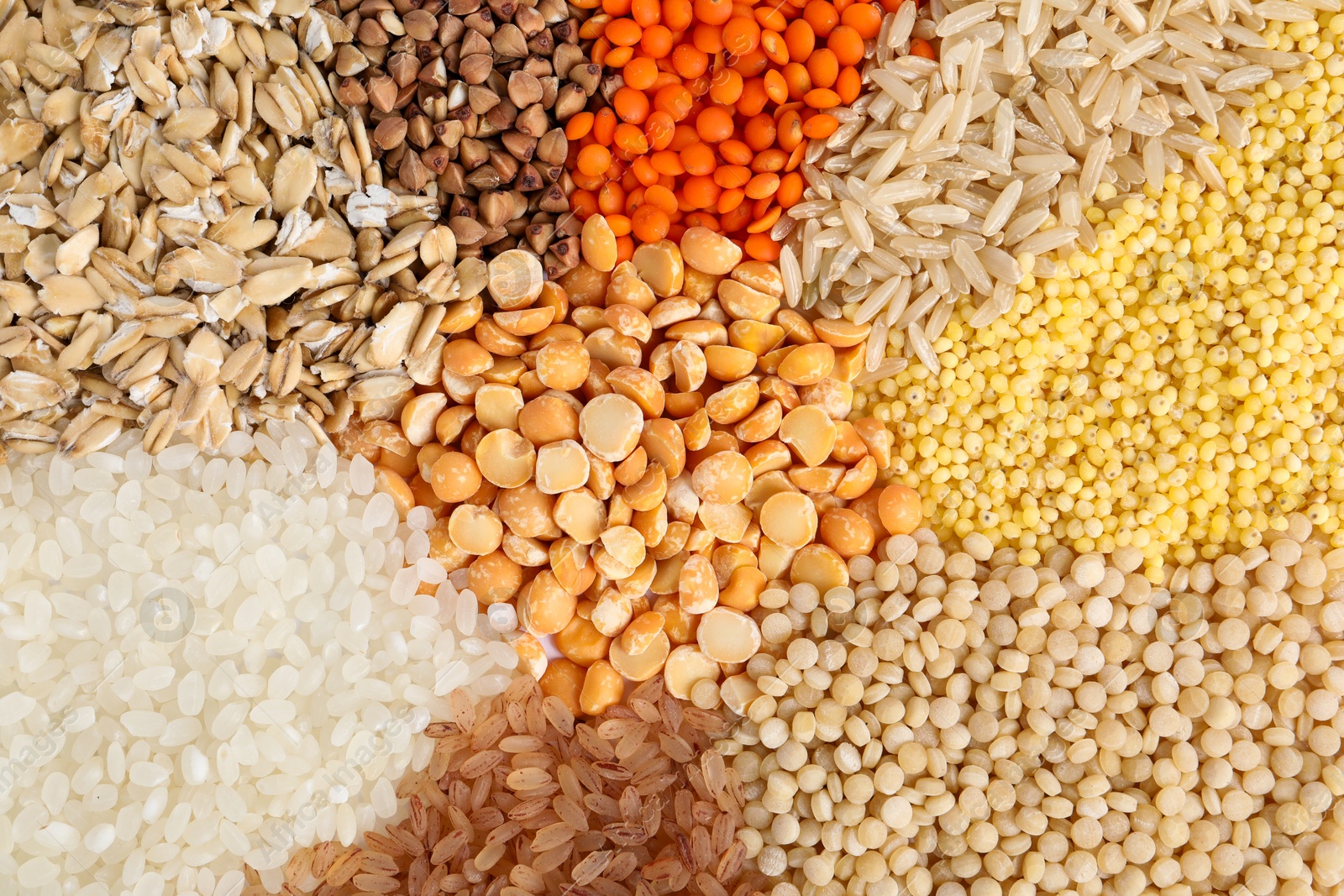 Photo of Different cereal grains as background, top view