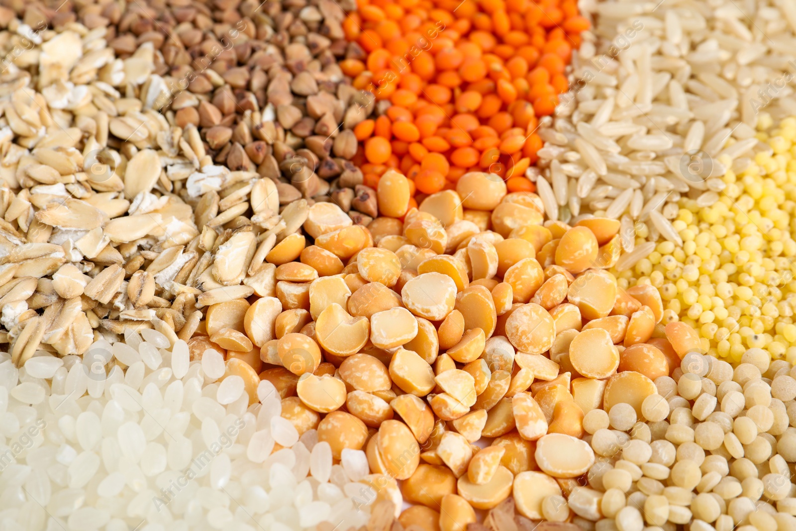 Photo of Different cereal grains as background, closeup view