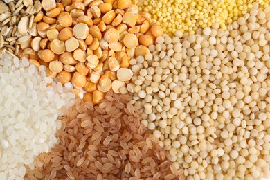 Photo of Different cereal grains as background, top view