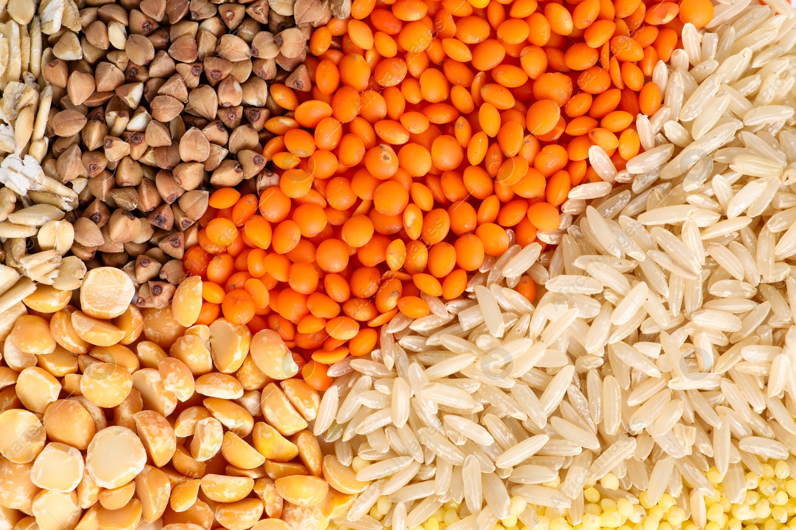 Photo of Different cereal grains as background, top view