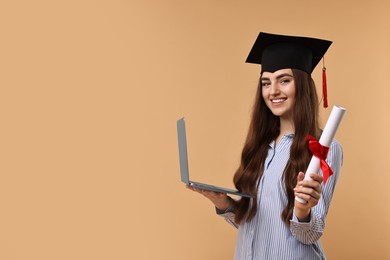 Happy student with diploma and laptop after graduation on beige background. Space for text