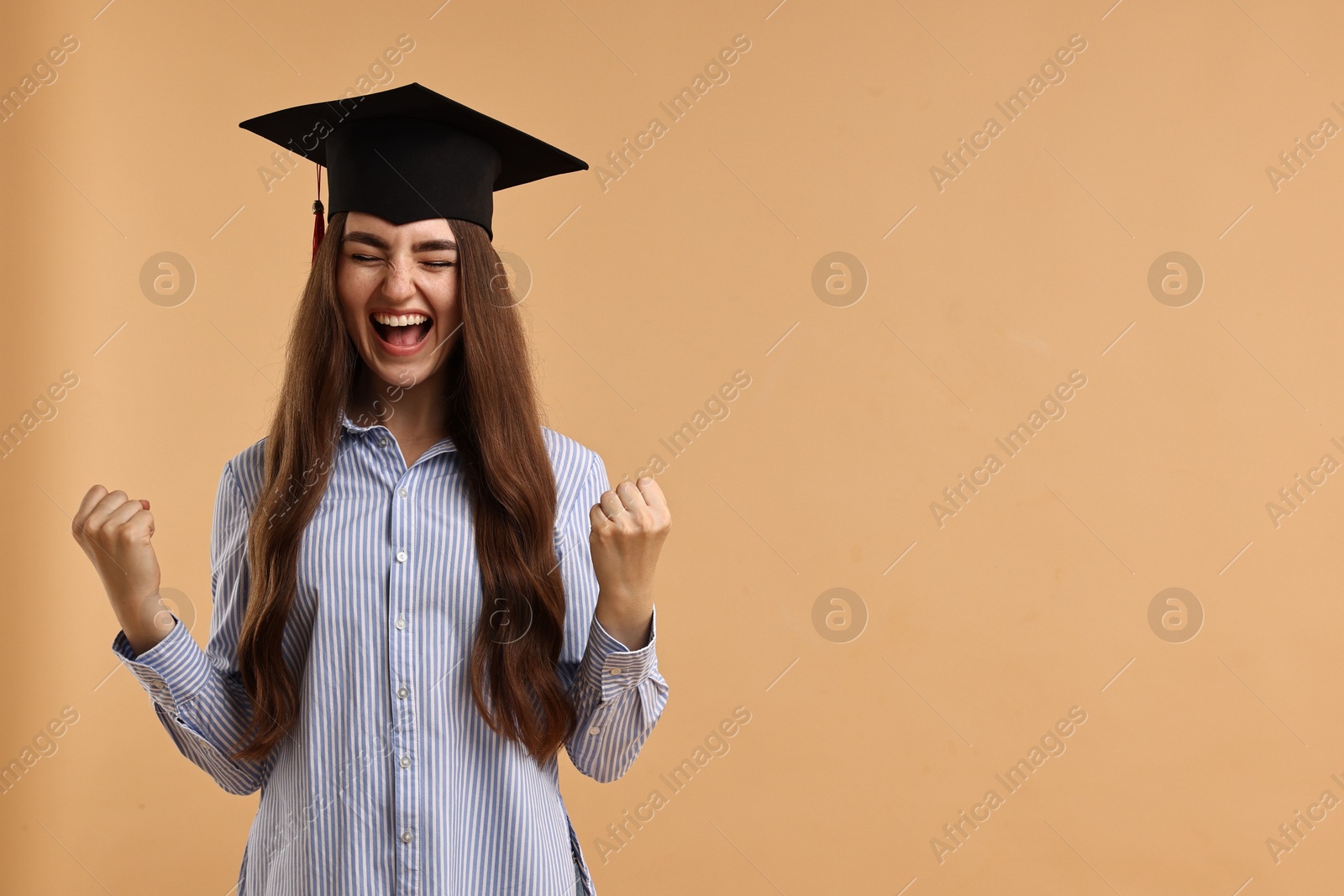 Photo of Happy student after graduation on beige background. Space for text