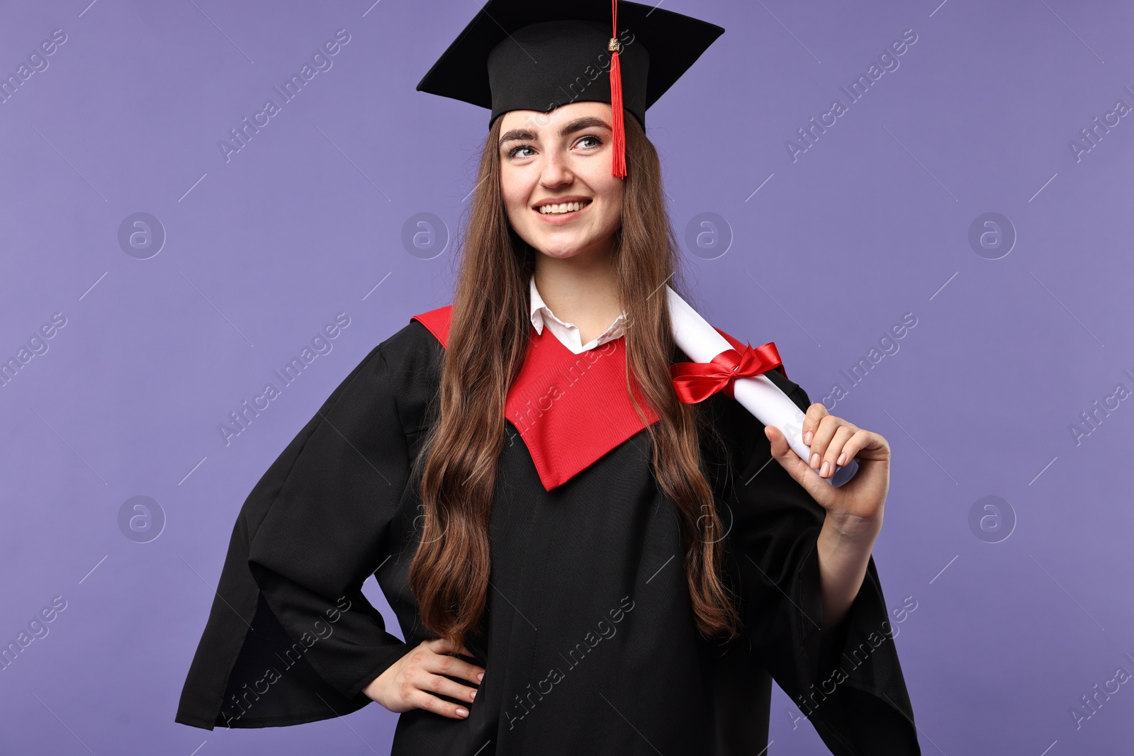 Photo of Happy student with diploma after graduation on violet background